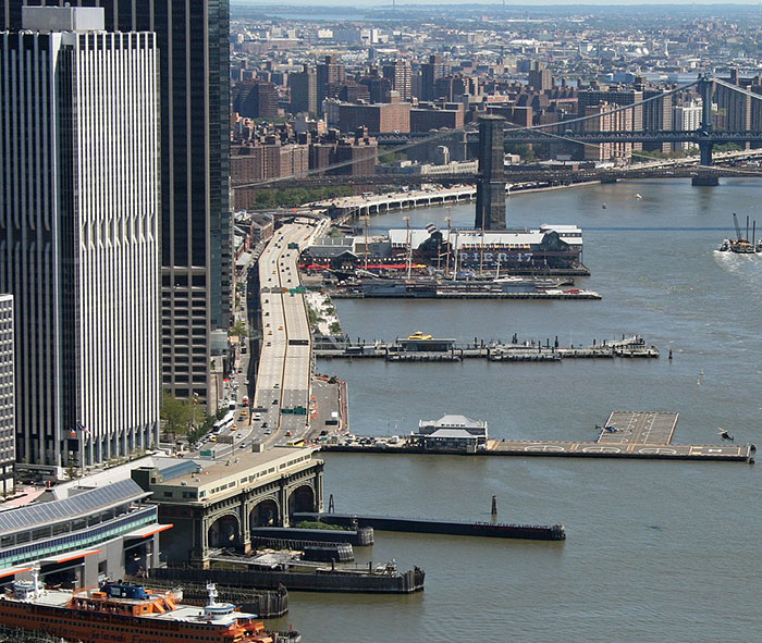 Aerial view of New York City waterfront, highlighting helicopter flight paths over the East River.
