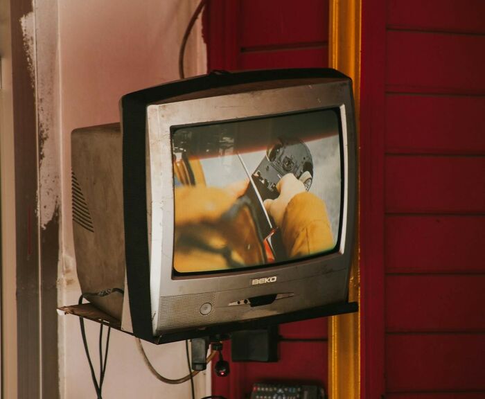 Vintage TV showing a close-up view of rotary phone dialing, evoking nostalgia for past communication methods.