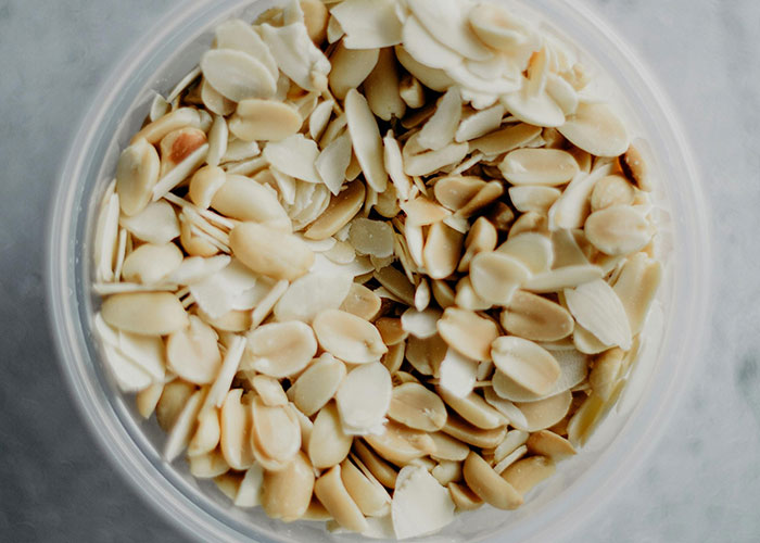 Sliced almonds in a bowl, possibly related to an unexpected event on a plane.