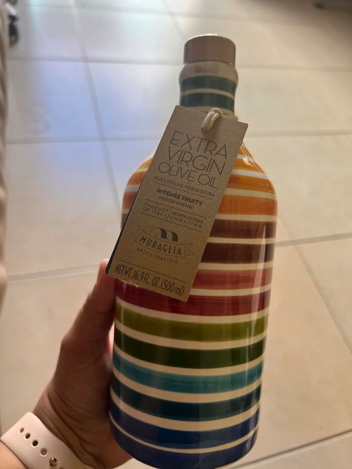 Colorful olive oil bottle held in hand, unique gift idea, not another "World's Okayest Friend" mug.