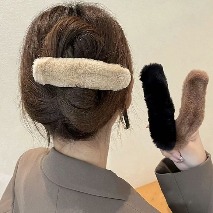 Woman with hair clips from an Amazon haul, showcasing budget-friendly shopping items.