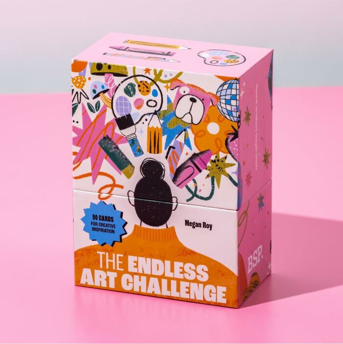 Colorful art challenge box featuring creative tools and designs, set against a pink background.