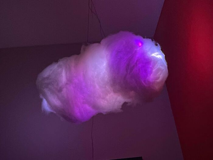 Glowing cloud lamp in a generic apartment adding ambiance with purple hues.