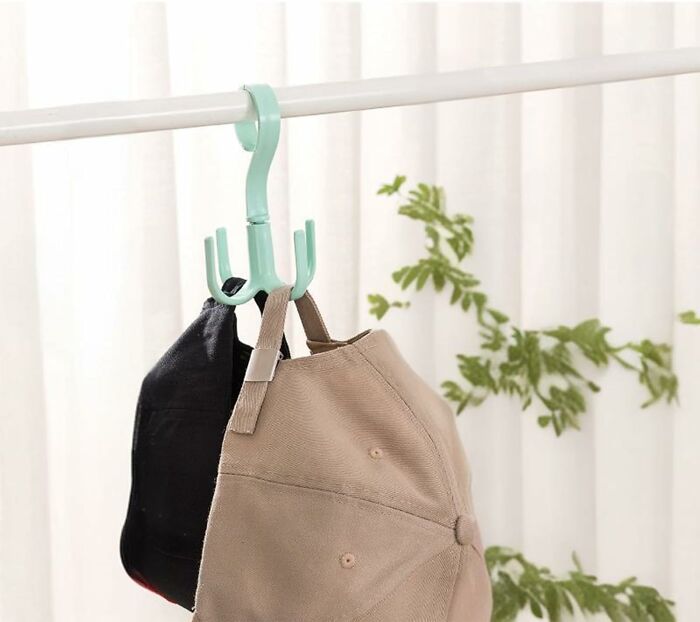 Caps hanging on a teal hook, showcasing an Amazon haul accessory for efficient storage.