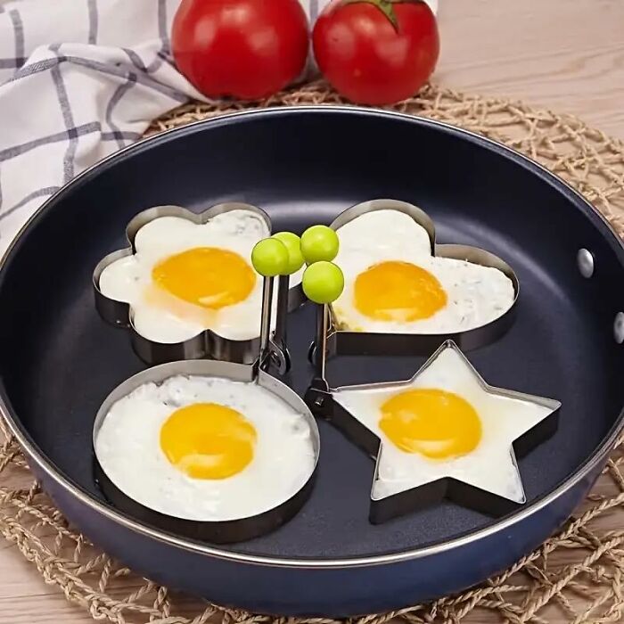 Fried eggs shaped like a flower, heart, star, and circle using kitchen tools from an Amazon haul for budget-friendly deals.