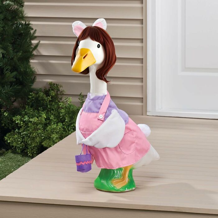Goose statue with a quirky wig and colorful apron, perfect for the "weird friend" in garden decor.