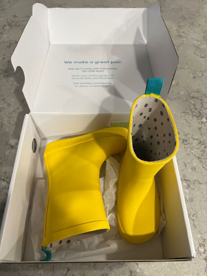 Yellow children's boots with polka dot lining in a box, resembling Easter treasures.