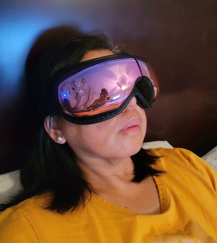 Woman wearing a high-tech eye massager, a unique Mother's Day gift idea for relaxation and self-care at home.