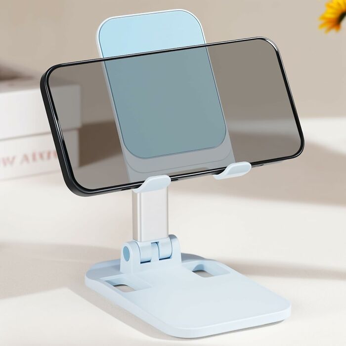 Adjustable phone stand holding a smartphone horizontally on a desk, one of the top Amazon haul finds.