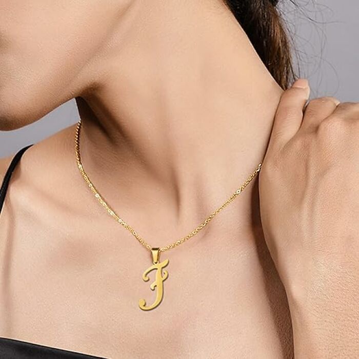Close-up of a gold necklace with an "F" pendant from Amazon Haul.