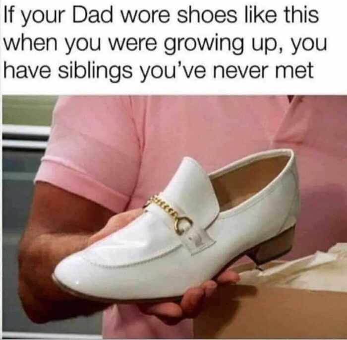 Man in pink shirt holding white dress shoe with gold chain, a funny meme to help insulate you from noise in the world.