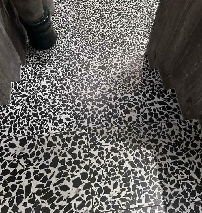 Confusing stairs with black and white tile pattern, showing a city planner oversight.