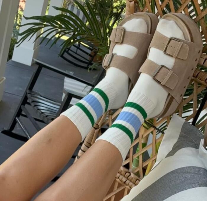 Feet in striped socks and sandals resting on a chair, embodying no-stress changes this spring.