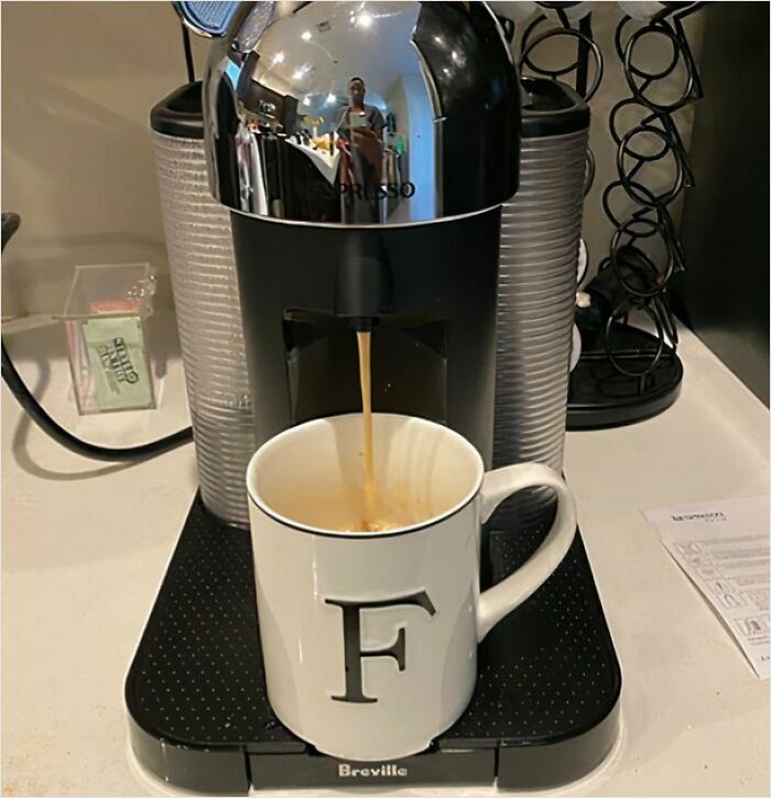 Espresso machine pouring coffee into a monogrammed "F" mug, representing a fresh start this spring.
