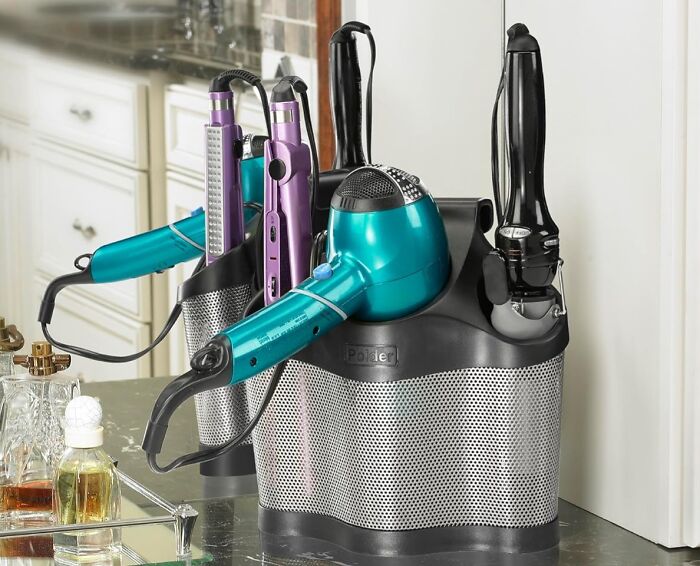 Hair styling tools organized in a sleek silver holder on a bathroom counter, showcasing perfect buys.