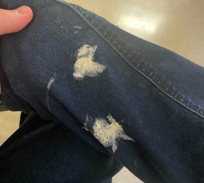Jeans with white stains, possibly ruined by paint, symbolizing a horrible day mishap.
