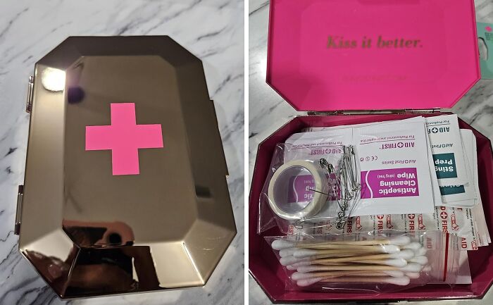 Festival survival kit from Amazon with pink cross, first-aid items inside, on a marble surface.