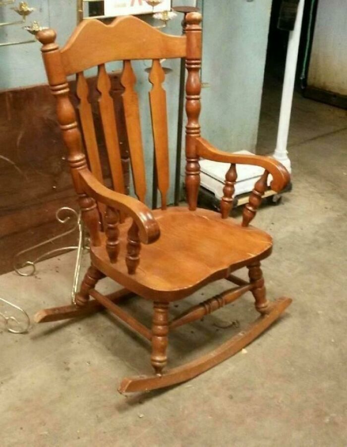 Wooden rocking chair with mismatched legs, illustrating a repair fail.