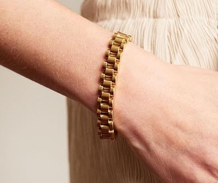 Gold bracelet on a wrist, a game-changer for your festival survival kit.