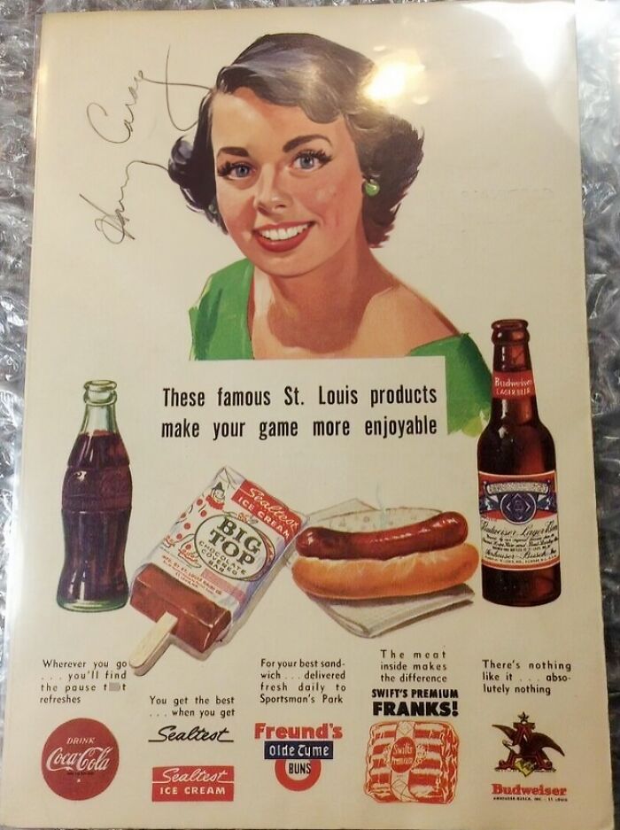 Vintage St. Louis ad featuring Coke, ice cream, hot dogs, and Budweiser, showcasing famous products.