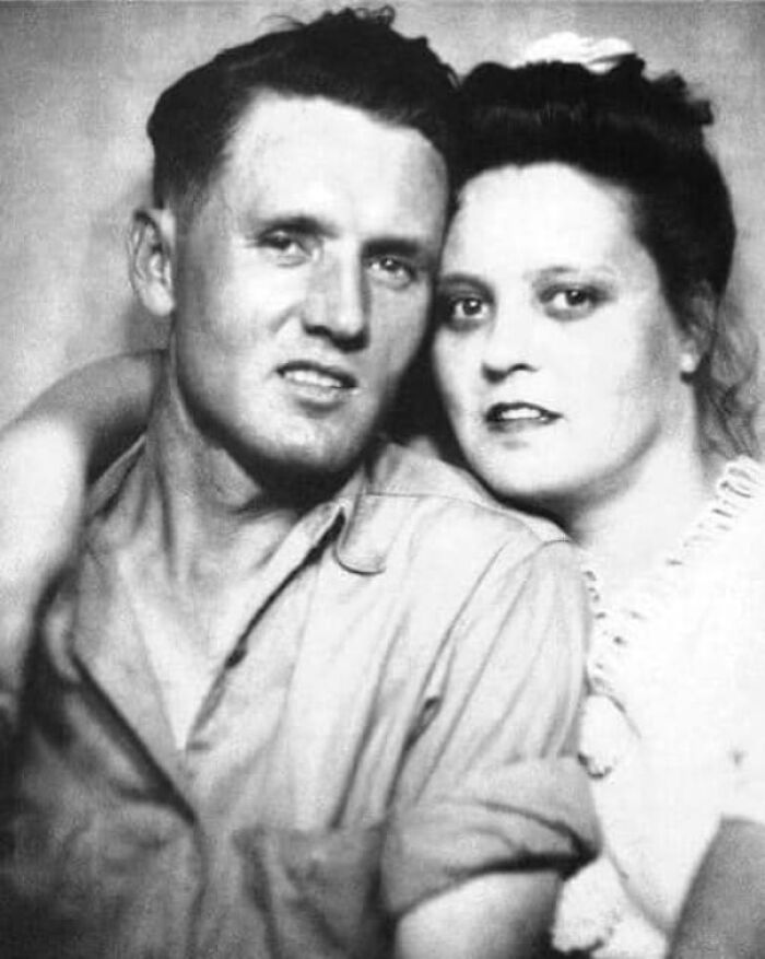Vintage couple embracing in a black and white photograph, capturing a historical moment.