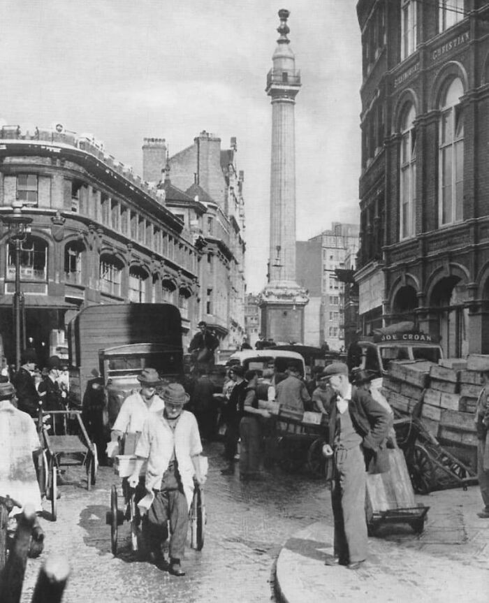Historic street scene with people, carriages, and the Monument in the background, shared by history enthusiasts.