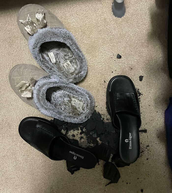 Fuzzy slippers and broken black shoes on carpet, illustrating a horrible day scenario.