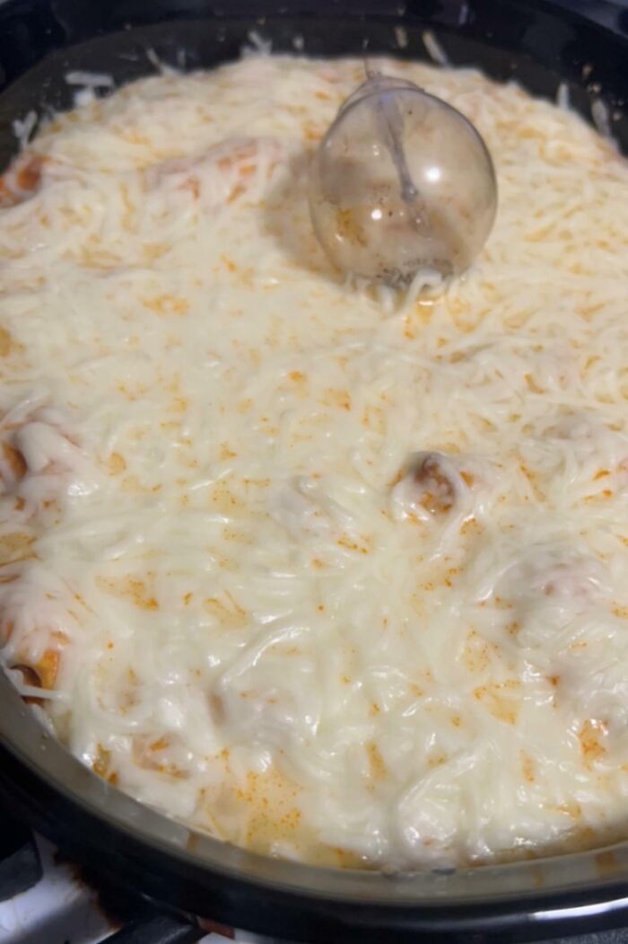 Baked dish with a glass lid accidentally cooked into the cheese, illustrating a horrible day mishap.