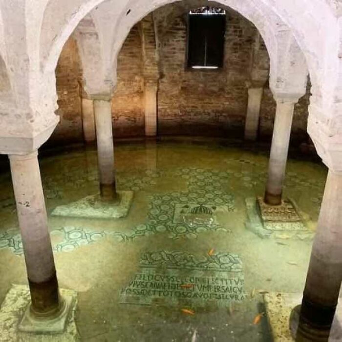 Ancient mosaic floor underwater with stone columns, perfect for history enthusiasts exploring fascinating old photos.