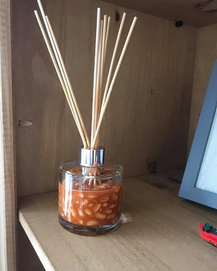 Glass jar with reed sticks, filled with a bean mixture, humorously mimicking a diffuser for unique IG posts.