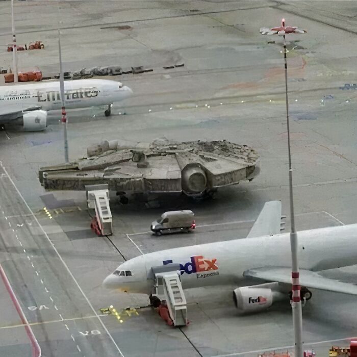 Millennium Falcon parked among planes at airport, humorous post from IG page.