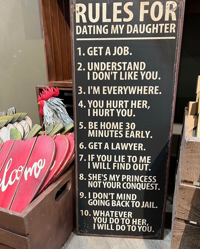 Sign displaying strict dating rules for a daughter, exemplifying ascent to cringe-worthy behavior.