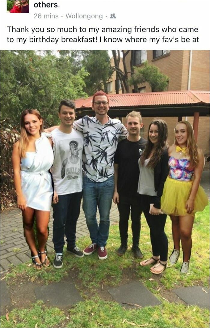 Group photo with friends at a birthday breakfast, showcasing amusingly awkward yet endearing moments.