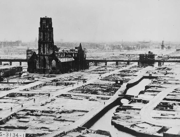 Ruins of a city during WWII, with a lone church remaining amidst widespread destruction.