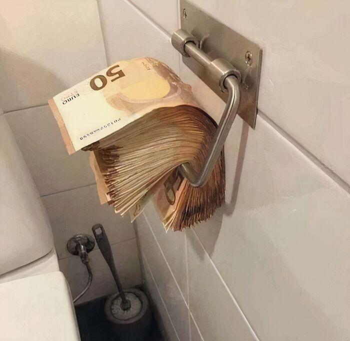 Euro bills hanging on a toilet paper holder, creatively capturing the essence of hardest posts humor.