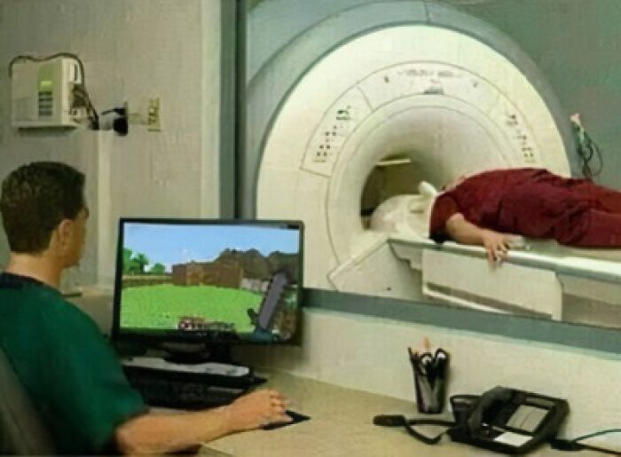 Technician playing a game while monitoring an MRI, capturing a hard post humor style.