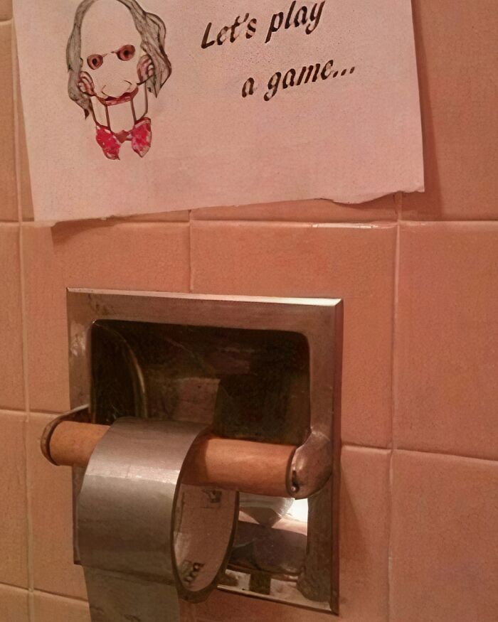 Drawing of a puppet with "Let's play a game" above an empty toilet paper holder.