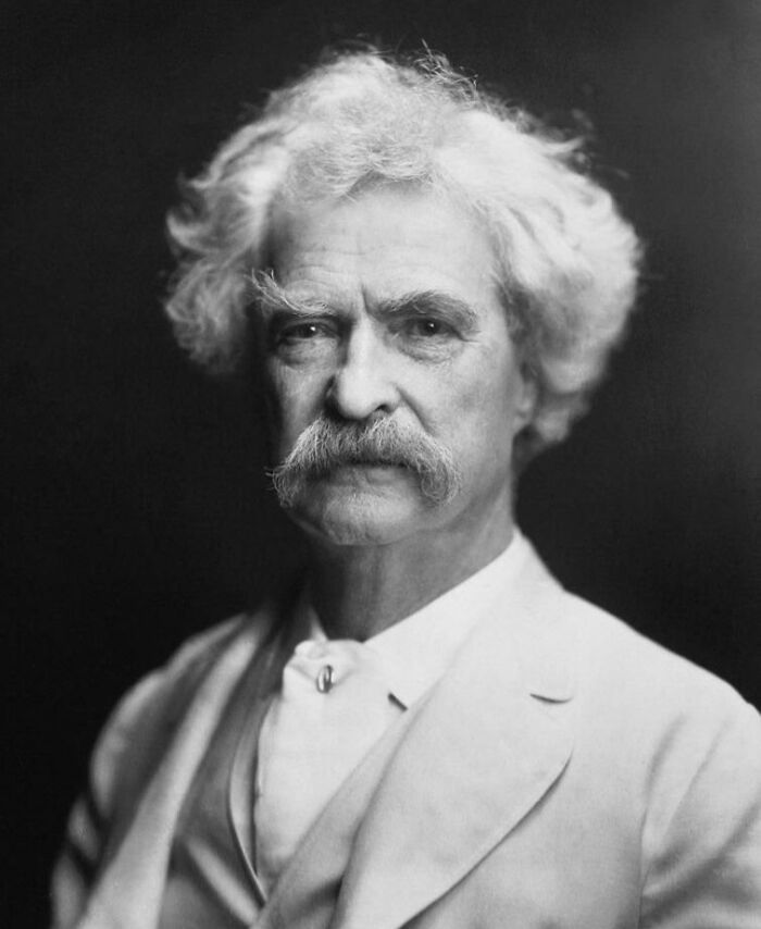 A person with white hair and mustache, wearing a light-colored suit, representing future predictions in history.