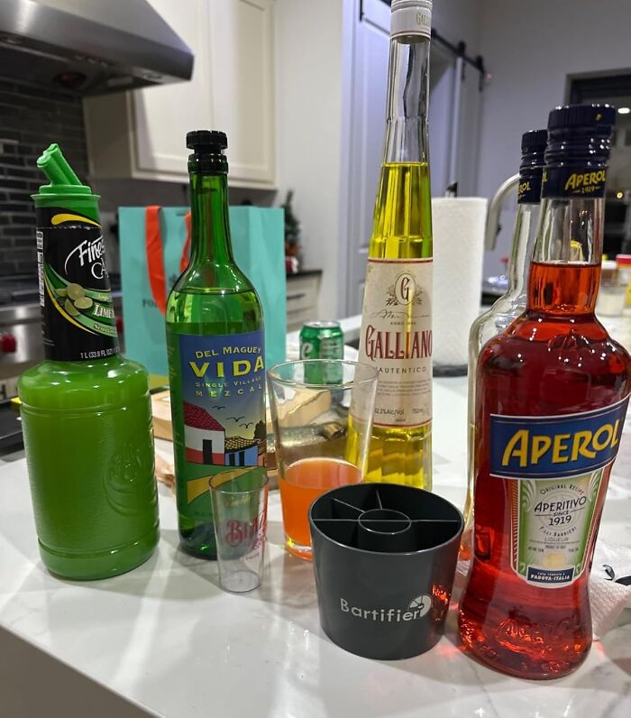 Bottles of various liquors and mixers on a kitchen counter, showcasing show-stopping finds for cocktails.