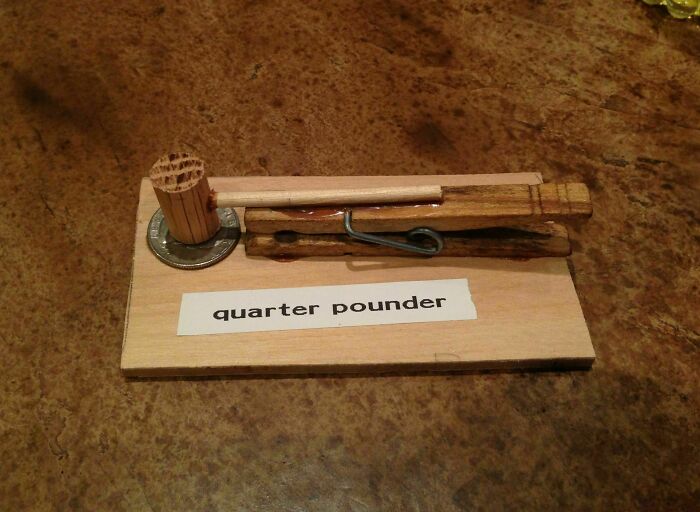 Elderly humor with a wooden mallet and clothespin on a board labeled "quarter pounder."