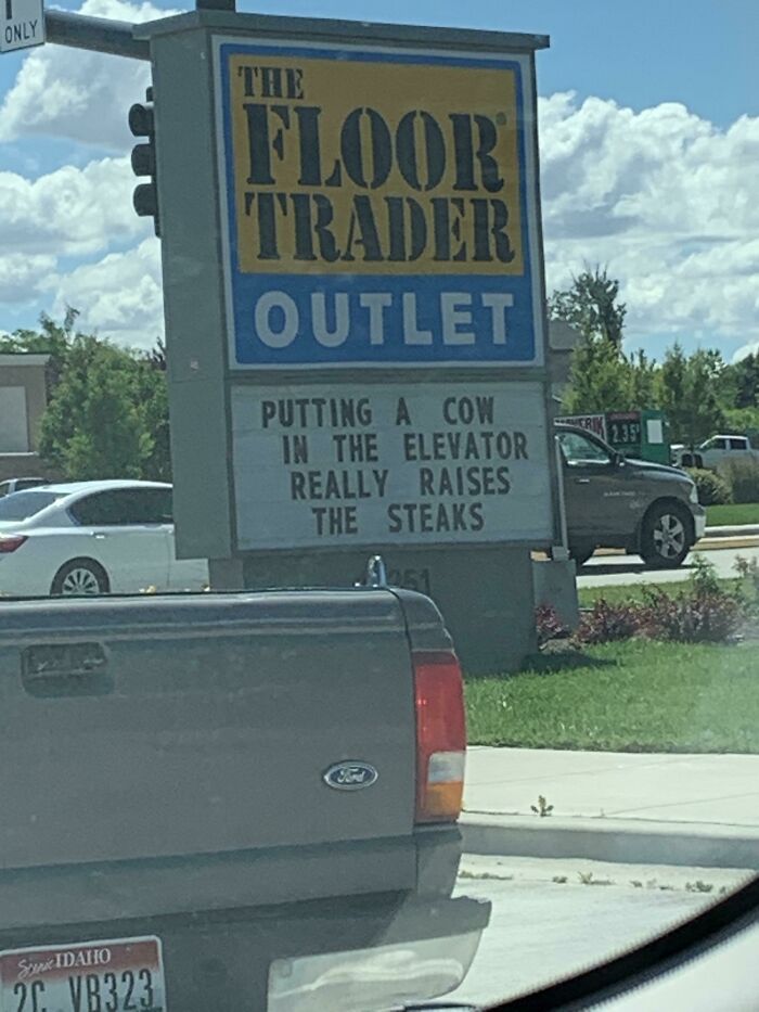 Funny sign at Floor Trader Outlet: "Putting a cow in the elevator really raises the steaks."