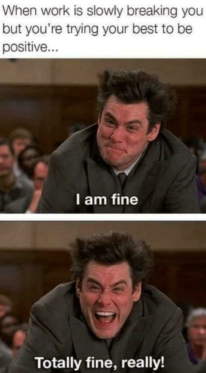 Man in a suit with stressed expression, attempting to stay positive, captures essence of funny work memes.