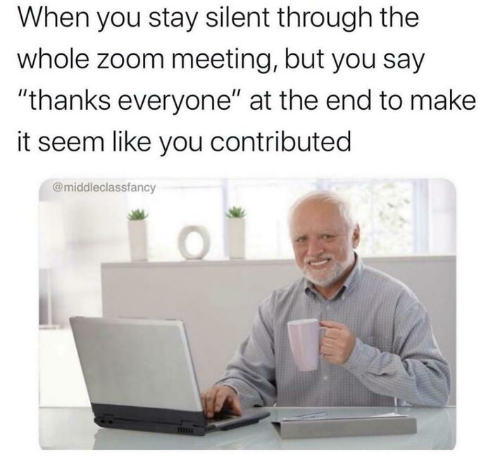 Man smiling with mug and laptop, illustrating a funny work meme about staying silent in Zoom meetings.