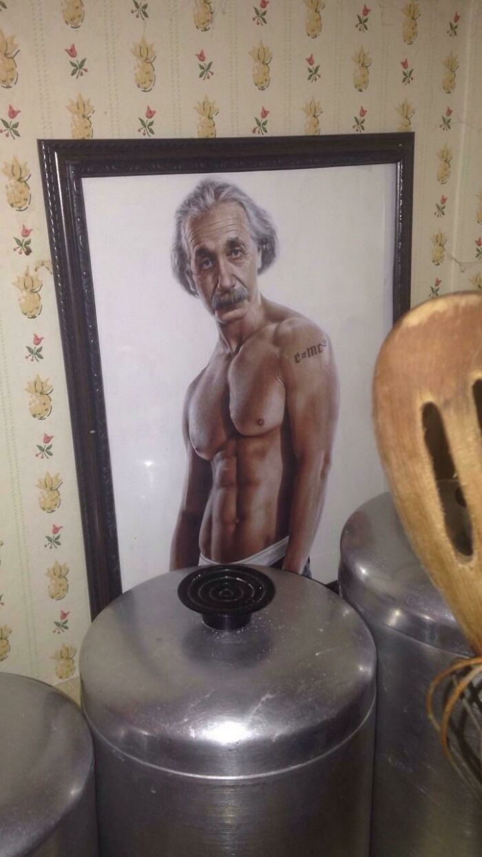 Elderly person with a muscular body in a humorous framed photo on a kitchen counter with metal containers.