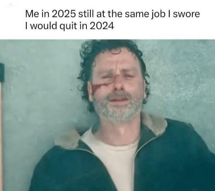 A man lying on the ground with a weary expression, captioned humorously about staying in the same job, representing work memes.