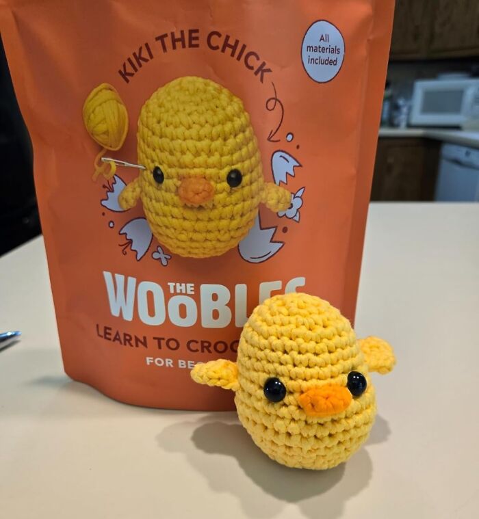 Crochet Easter treasure kit featuring Kiki the Chick on a table, with crocheted chick in front.