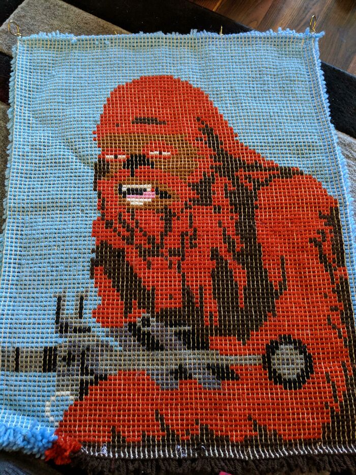 Pixel art of a humorous Wookiee crocheted by an elderly person, showcasing funny creativity.