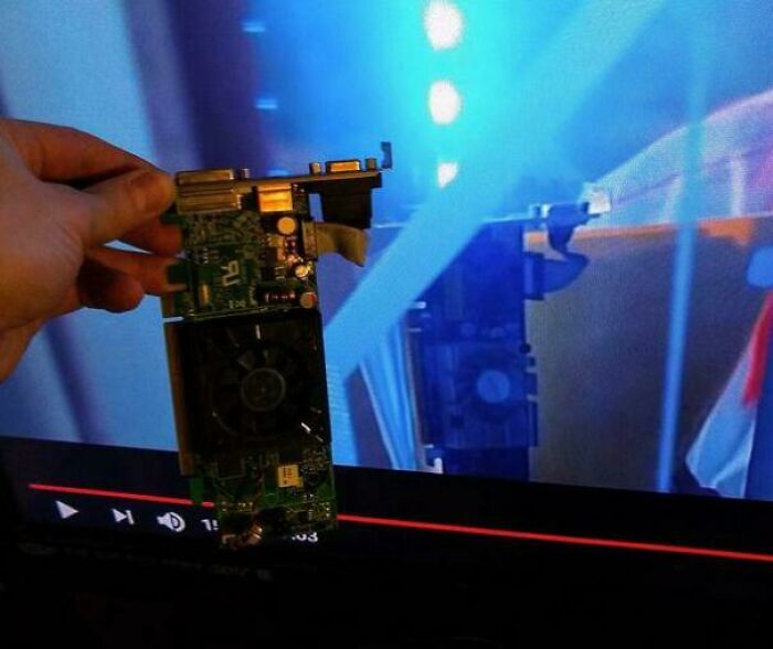 Hand holding a computer chip in front of a screen, showing creative use of props by filmmakers.