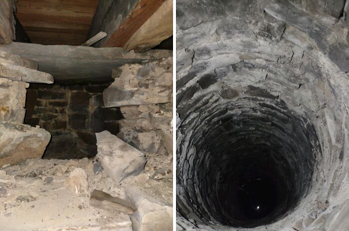 Pozo profundo de aspecto peligroso rodeado de piedras y paredes de ladrillo en una estructura antigua.