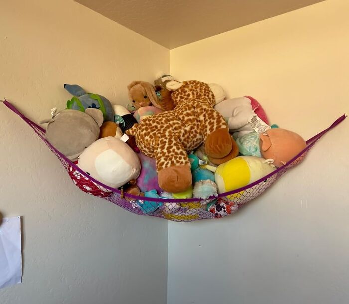 Stuffed animals in a corner hammock, a trending Amazon mover and shaker storage solution.